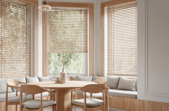 Breakfast nook with natural wood blinds on a bay window